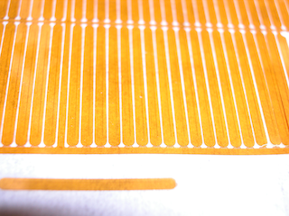 Small Polymer nozzle-plates, micropatterned conical spray orifices